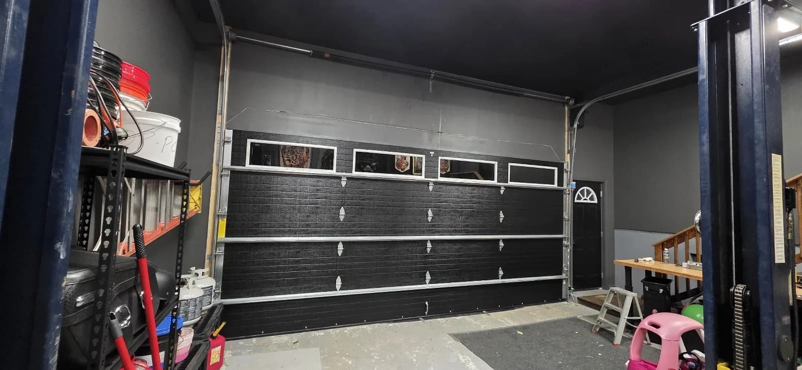 Interior view of a garage door in Rocky Hill, CT with high lift tracks installed high near the ceiling.