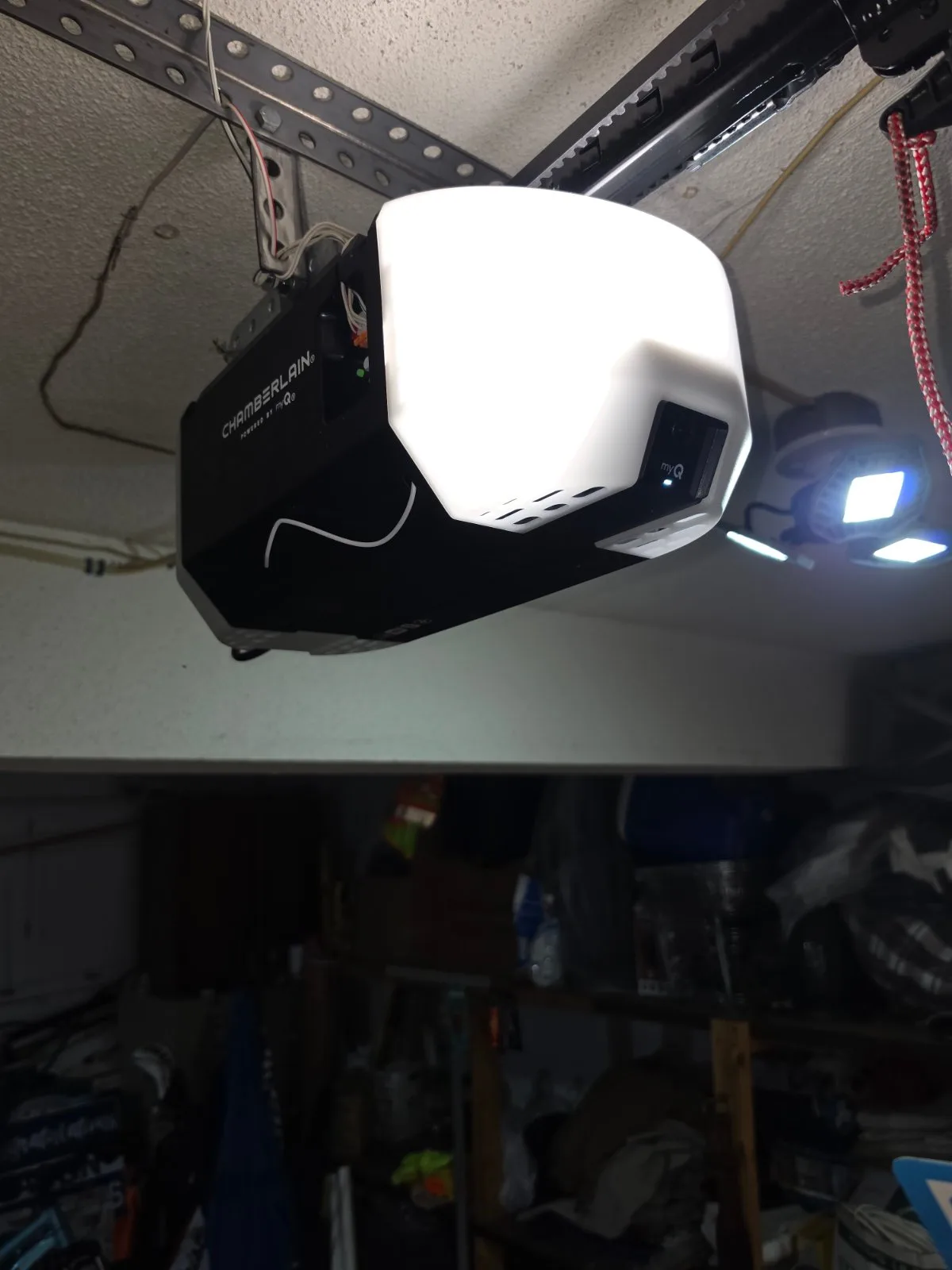 A Chamberlain belt drive garage door opener with its light illuminated, mounted on a garage ceiling in Rocky Hill, CT.
